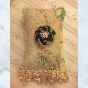 antique pillow with brooch